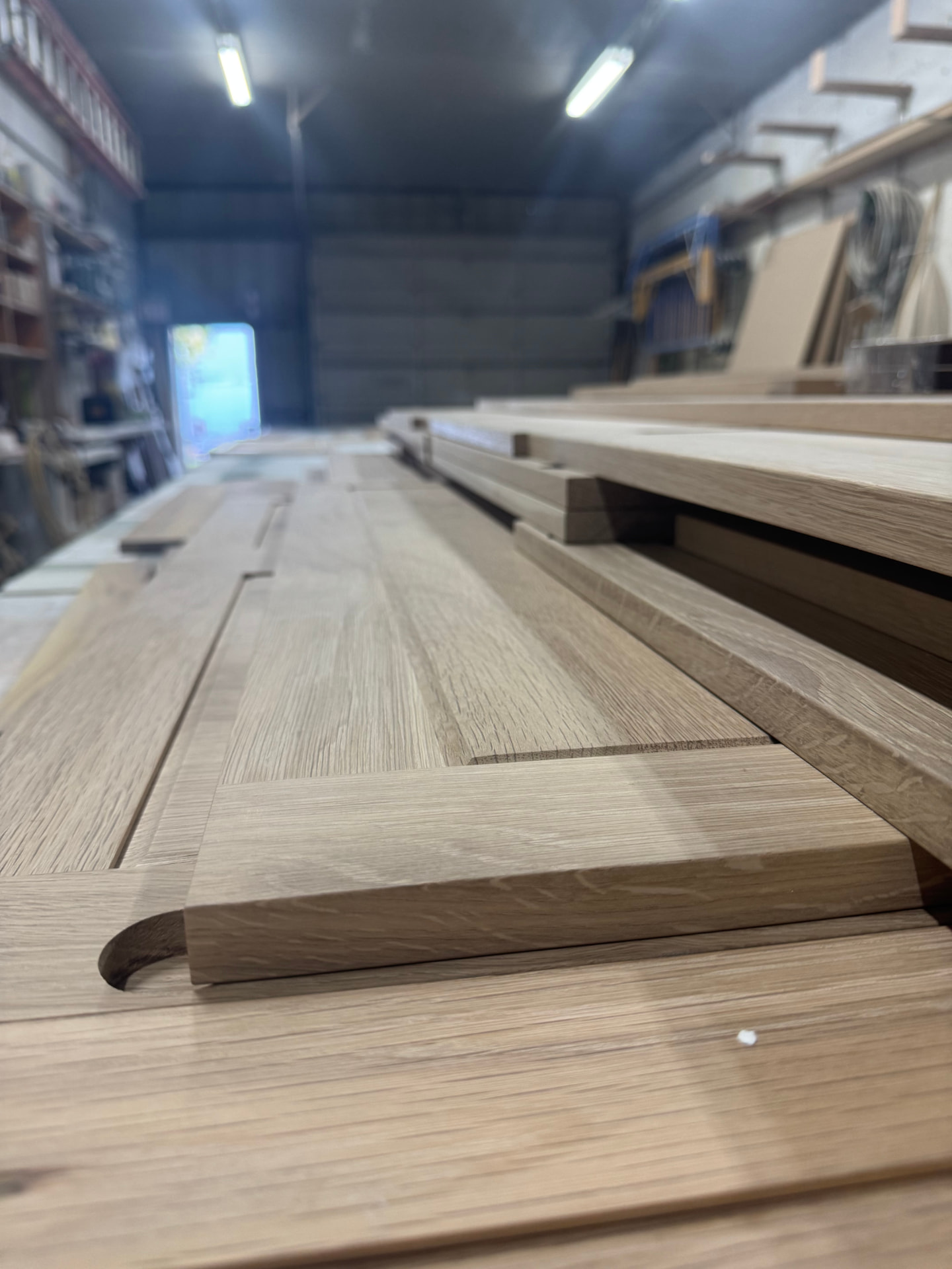 Close-up of a white oak cabinet door rail and profiled edge before finishing